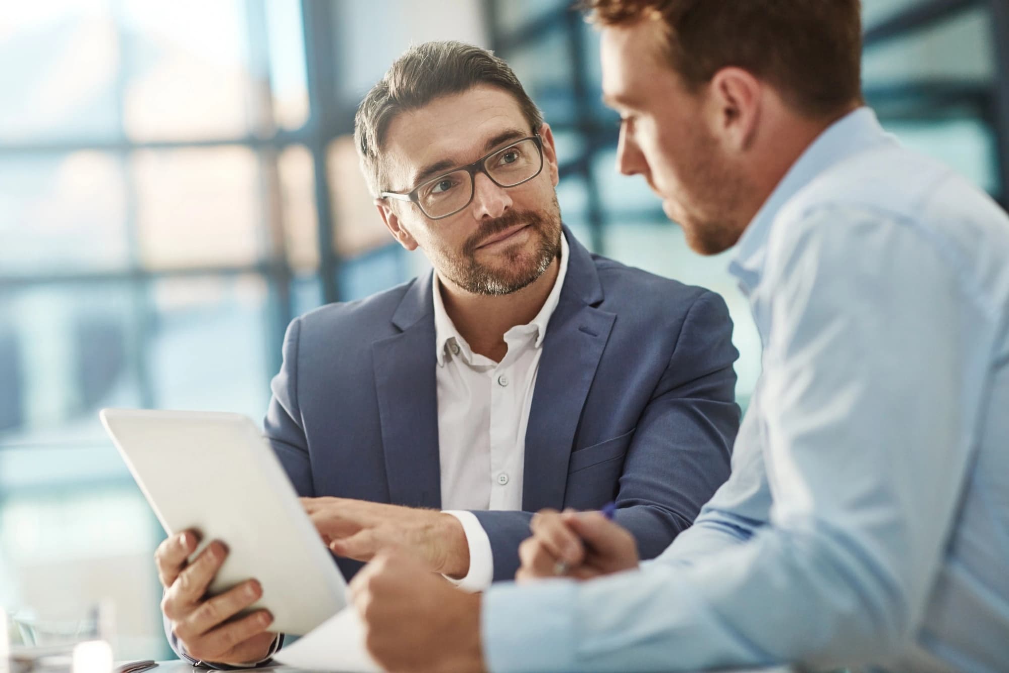 Businessman in glasses talking to a key-person insurance representative